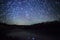 Beautiful night sky, spiral star trails and the forest