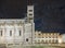 Beautiful night view of the Cathedral of San Martino with cloudy sky from which the moon appears, Lucca, Tuscany, Italy