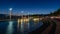 Beautiful night view of fountains, streetlamps at port of Ouchy, Lausanne, Switzerland. Landscape and reflection in water