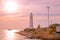 Beautiful nightly seascape with lighthouse and moody sky at the sunset