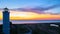 Beautiful nightly seascape with lighthouse and moody sky at the sunset