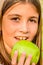 Beautiful nine year old girl eating apple