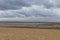 Beautiful North Sea coast of Cuxhaven in Germany. Overcast sky with clouds over the sea at low tide