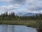 Beautiful northern landscape with river basin of Kamajokk, boulders, mountain peaks and spruce tree forest in Kvikkjokk in Swedish