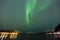 Beautiful northern lights over a fjord at night