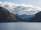 Beautiful Norwegian fjord. View across Storfjorden, towards village Eidsdal. Summer, blue sky. Norway