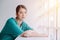 A beautiful nurse sits in a chair with a gloomy and anxious expression