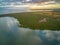 Beautiful ocean coastline with mangroves and agricultural fields at sunset - aerial view.