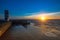 Beautiful ocean sunset at the stone pier in calm weather. Nature.