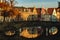 beautiful od buildings reflected in water of canal at sunlight,