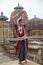 Beautiful Odissi dancer striking pose against the backdrop of Mukteshvara temple with sculptures in bhubaneswar, Odisha, India