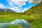 Beautiful Offensee lake landscape with mountains, forest, clouds and reflections in the water in Austrian Alps