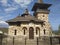 Beautiful old church, built of stone. Extraordinary combination of stone shades. In the background is a cemetery