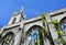 A Beautiful old church with gothic windows and tower pointing to the blue sky