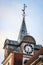 Beautiful old church tower with clock. Old building with cloudy overcast background