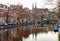 Beautiful old houses on the city embankment of Amsterdam at dawn.