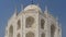 A beautiful old mausoleum of the Taj Mahal against the blue sky.