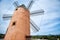 Beautiful old spain windmill against colorful sky with clouds. Spring landscape in the morning in Paguera. Rural scene