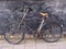 Beautiful old, vintage and retro bicycle, dating from 1950`s parked in the passage between old houses secured with chain. Natural