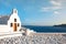 Beautiful old white church against the blue sky and blue Aegean sea. Oia, Santorini, Greece, Europe. Classic white Greek