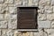 Beautiful old window frame with old wooden shutters on ancient pale rock wall. Rural antique window frame. Design element.