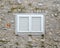 Beautiful old window frame with white wooden shutters and ancient pale stone wall. Rural antique window frame. Design element. Tem