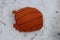 Beautiful old and worn basketball lying in the snow