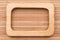 Beautiful one-piece light wooden frame, lies on bamboo mat.