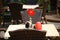 Beautiful open air summer restaurant tables with red flower in vase