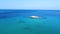 Beautiful open blue sea and rocky island in the middle. Aerial drone view