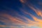 Beautiful orange feather clouds on a blue sky at sunset, magical background, autumn, spring, summer. Weather forecast