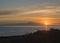Beautiful orange sky before sunrise over calm ocean and silhoutte of mountain pico del Teide at Tenerife seen from La
