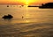 Beautiful orange summer sunset in small village port with many boats mooring