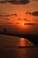 Beautiful orange sunset with building, island and clouds