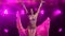 Beautiful oriental belly dancer is passionate dancing on a purple background in the smoke. Young girl in posh oriental