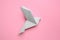 Beautiful origami bird on pink background, flat lay