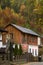 Beautiful original house in English style- brick and wood combination  / barn in autumn landscape.