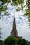 Beautiful ornamental sacred white buddhist pagoda spire of Wat Chalong temple with blue sky and white cloud background