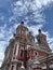 Beautiful orthodox church with a chapel in the city with amazing clouds and sky.