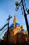 Beautiful Orthodox Church of red brick with a blue roof, with Golden domes at sunset. Russia, Belgorod. General appearance.