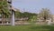 Beautiful outdoor fountain with water jet streams up on a sunny day in a city park.