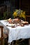 Beautiful outdoor still life in country garden with bundt cake on wooden stand on rustic table