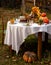 Beautiful outdoor still life in country garden with chocolate bundt cake on plate on round table