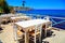 Beautiful outdor cafe on sea coast, Crete island, Greece.