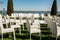 Beautiful outgoing wedding set up.Romantic wedding ceremony , wedding outdoor on the lawn water view. Wedding decor. White wooden