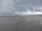 Beautiful overcast sky over the sea with reflections on the water on the beach at Stilbaai, South Africa