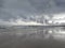 Beautiful overcast sky with reflections on the water on the beach at Stilbaai, South Africa