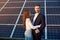 Beautiful pair standing embracing on a background of solar panels