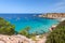 Beautiful Panorama of bay Cala Hort with sea sailing yachts. Ibiza, Balearic Islands, Spain