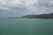 Beautiful panorama day shot of calm blue turquoise ocean water with wild islands, white sand beaches, jungle hills, light blue sky